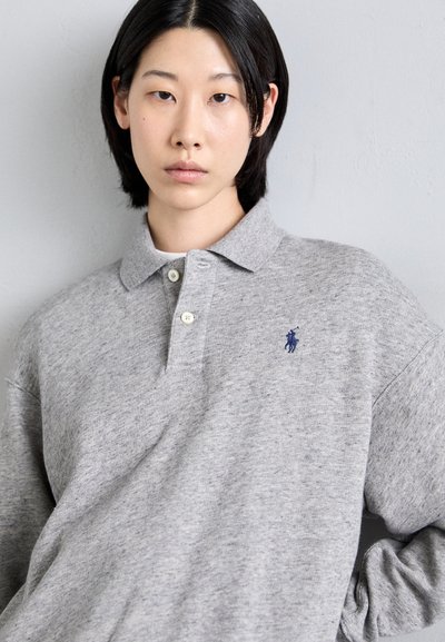 Gray long-sleeve polo shirt with a collar, two buttons, and an embroidered blue logo on the left side. Soft, textured fabric.
