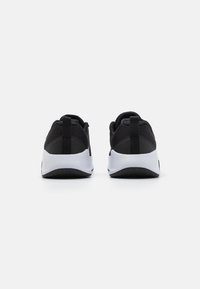 Černé sportovní tenisky z prodyšné síťoviny s bílou mezipodešví a černou podrážkou. Vyznačují se zakulaceným tvarem a dvěma úchyty na patě.