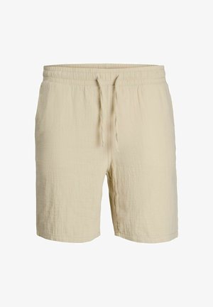 Beige bomullsshorts med elastisk midje og snor. Myk, strukturert stoff med en avslappet passform og lengde over kneet.