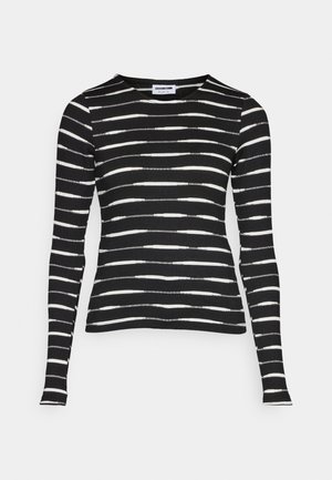 Black long-sleeve top with horizontal white stripes. Ribbed texture, crew neckline, slim fit, and straight hem.