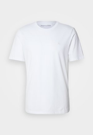 Short-sleeve white t-shirt made of cotton. Features a crew neckline and a small embroidered logo on the left chest area.