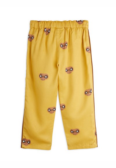 Κίτρινο παντελόνι με ελαστική μέση που διαθέτει επαναλαμβανόμενο σχέδιο με πρόσωπα εξωγήινων σε καρτούν και καφέ λωρίδες στο πλάι.
