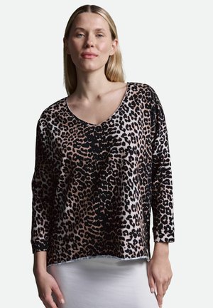 Leopard print long-sleeve top in soft fabric, featuring a V-neck, loose fit, and black accents on a pink background.