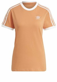 Orange bomullströja med vit rund krage och ärmkanter. Har tre vita ränder på varje axel och en Adidas-logotyp på bröstet.