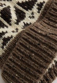 Brown knit scarf featuring a cream geometric pattern and textured ribbed hem. The material appears thick and warm, with a soft finish.