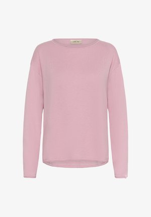 Gaiši rozā tops ar garām piedurknēm un apaļu kakla izgriezumu, mīkstas adījuma tekstūras un brīva piegriezuma, ar nedaudz izliekta apakšmala un minimālu zīmola apzīmējumu.