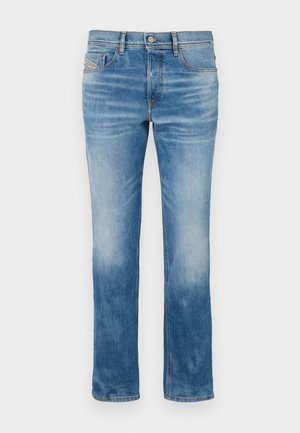 Light blue denim jeans with a straight leg design, five pockets, and slight fading near the knees. Features orange stitching and a button closure.
