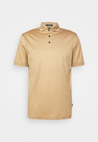Beige kortärmad polo med tre svarta knappar och klassisk krage, visad mot en enkel vit bakgrund.