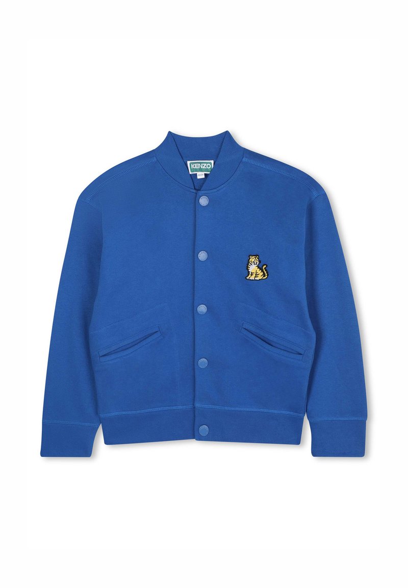 Sweat-shirt bleu avec un col côtes, fermeture à boutons, deux poches latérales et un logo de tigre brodé sur la poitrine gauche.