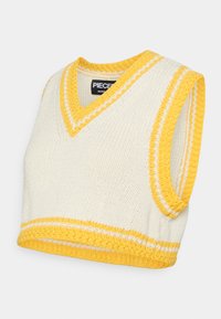 Sweater cropped em creme com detalhes em listras amarelas e brancas. Textura tricotada, design sem mangas e barra canelada. Etiqueta da marca visível.