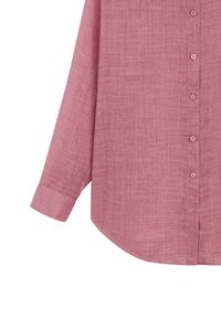 Long-sleeve pink linen shirt with buttoned cuffs and a curved hem, partially buttoned down the front.