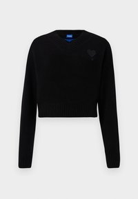 Black cropped sweater with a V-neck, ribbed hem, and long sleeves. Features a small textured heart detail on the chest. Made of soft material.