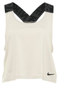 Haut de sport beige sans manches avec larges bretelles croisées noires et petit logo Nike swoosh noir en bas à droite.