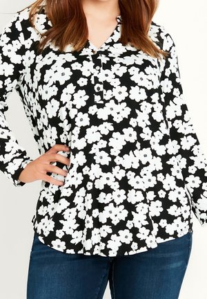 Langsleeve blouse met een zwarte achtergrond en een wit bloempatroon, voorzien van een knoopkraag en een relaxed fit. Gemaakt van lichtgewicht stof.