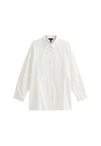 Vit långärmad skjorta i textil med struktur, med klassisk krage, knapplist framtill och en avslappnad passform.