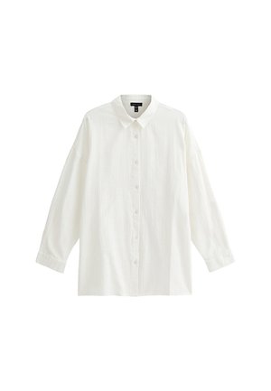 White long-sleeve shirt made of textured fabric, featuring a classic collar, button front, and relaxed fit.