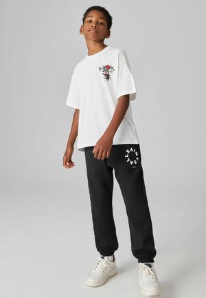 REGULAR FIT - TIERRA CUFFED LOGO JOGGERS - Jogginghose - black