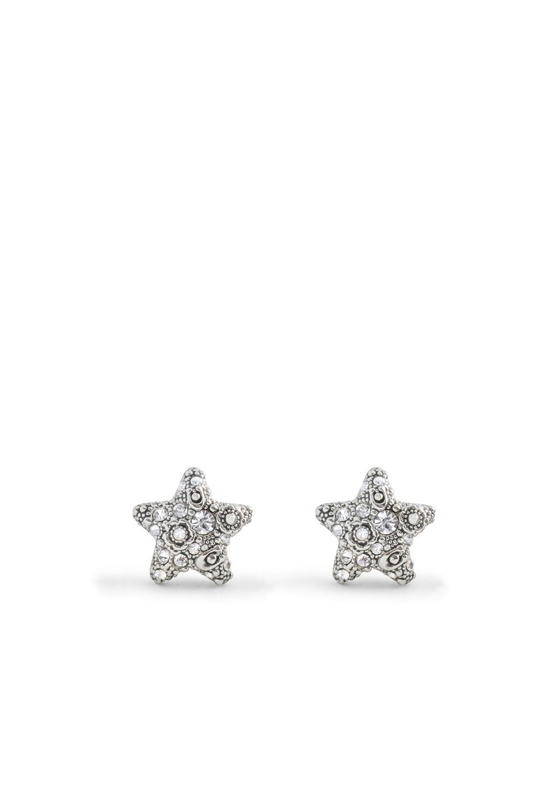 Boucles d'oreilles en forme d'étoile argentée ornées de cristaux transparents et de détails complexes. Petit design en clou, adapté pour un port quotidien.