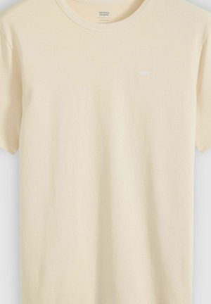 Beige T-shirt med korte ærmer og rund hals, med lille Levi's-logo på venstre bryst, vist på ensfarvet baggrund.