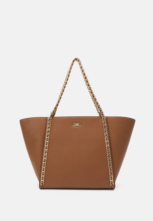 Brown faux leather tote bag with a triangular shape, featuring a gold chain strap and a small logo on the front. Smooth texture.