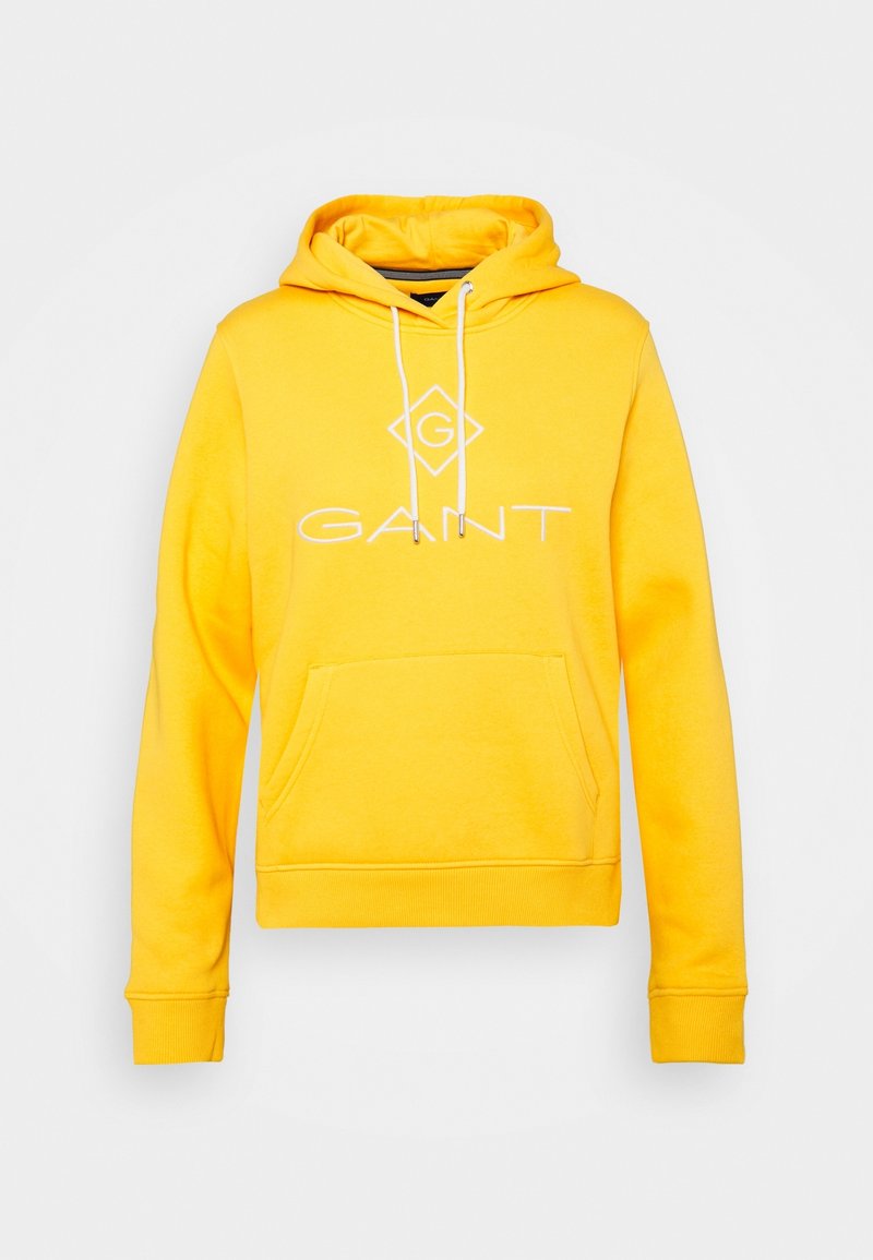 Sudadera de algodón amarilla con bolsillo canguro en la parte delantera, capucha con cordón, y logo impreso en blanco "GANT" con una forma de diamante encima.