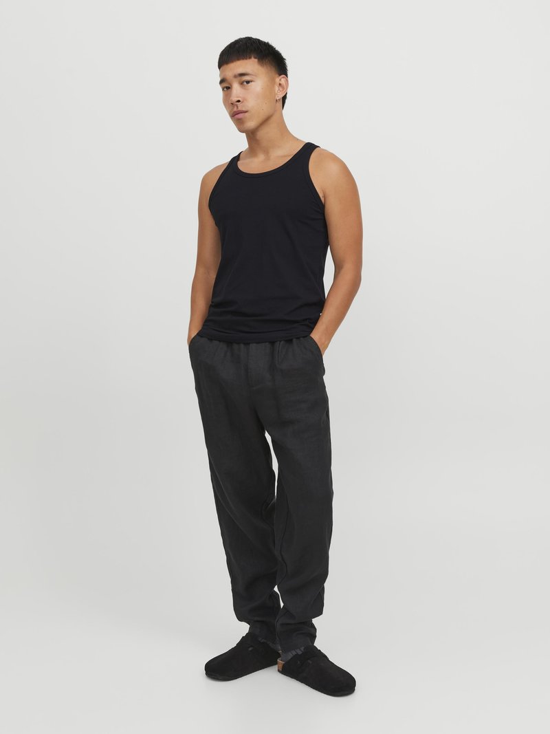 Black tank top, black loose-fitting pants, and black slip-on shoes. Fabric appears soft with a smooth texture; minimal design and no patterns.