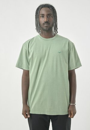 Green cotton t-shirt featuring a crew neckline and short sleeves. Includes a small blue logo on the chest. Loose fit, smooth texture.