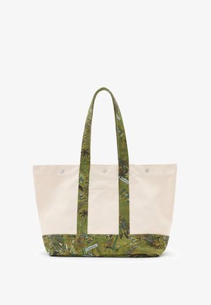 Torba tote z płótna o kremowym kolorze, z zielonym tropikalnym wzorem, dwiema grubymi rączkami oraz metalowymi zapięciami na napy z przodu.