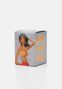 Empaque gris para "Magic Bodyfashion Boob Tape", que presenta una ilustración de una mujer. Las instrucciones y ejemplos de uso están impresos en los lados.
