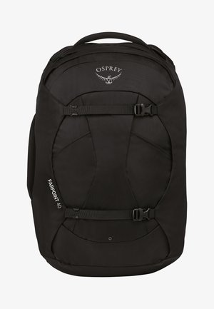 Sac à dos Osprey Farpoint 40 en noir, fabriqué en tissu résistant, dispose de boucles réglables, d'un design plat et d'accents de surface profilés.