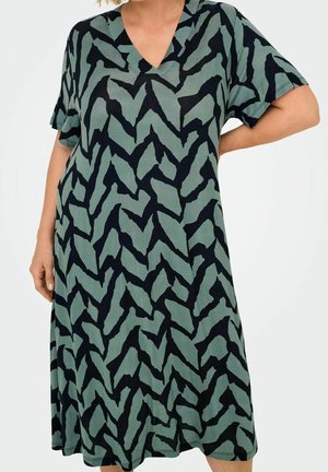 Green dress with a V-neckline and short sleeves, featuring a black zigzag pattern and a soft, textured fabric.