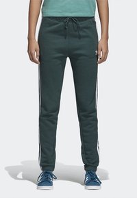 Green sweatpants with side stripes, elastic waistband, and drawstring. Made of soft fabric, featuring a relaxed fit and ribbed cuffs.