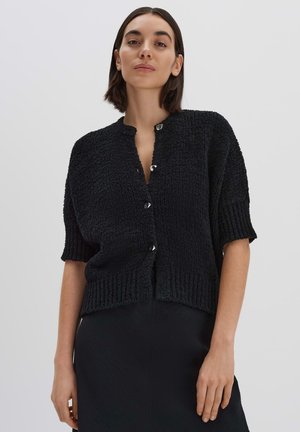 Black, textured knit cardigan with short sleeves, a round neckline, and silver button closures along the front. Minimalist design.