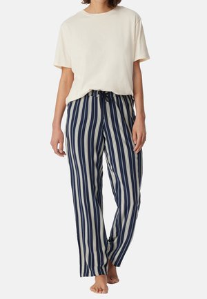 Beige bomullströja i kombination med marinblå och krämrandiga sweatpants med elastisk midja och snörning, i en lös passform.