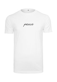Hvid bomulds t-shirt med korte ærmer og sort kursiv tekst, der staver "peace" centreret på brystet. Simpelt design.