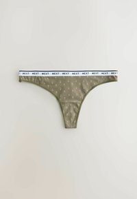 String-tanga vert olive avec un petit motif floral rose et une taille élastique blanche portant en répétition le texte "NEXT" en lettres noires.