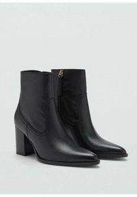 Botas de cuero negro hasta el tobillo con punta afilada y tacón cuadrado. Presentan un zipper lateral y un detalle de costura minimalista. Textura suave.