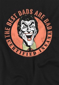 Black T-shirt featuring a graphic of a smiling character with slick black hair, surrounded by text in orange and white: "THE BEST DADS ARE BAD, CERTIFIED INSANE."