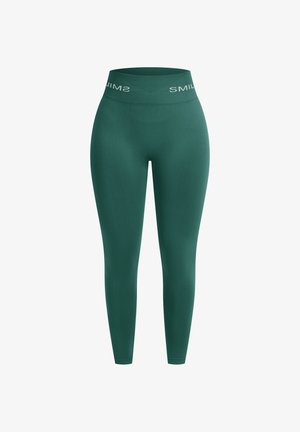 Leggings verdes con una cintura alta que presenta el logo blanco "SMIL". Textura suave y forma ajustada, diseñados para comodidad y flexibilidad.
