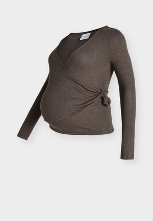 Maglia premaman marrone a maniche lunghe con design a incrocio, caratterizzata da un fiocco sul lato e un tessuto morbido e testurizzato.