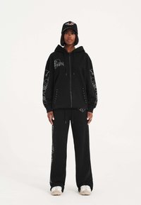 Ed Hardy - CRYSTAL SKULL RELAXED JOGGERS  - Tracksuit bottoms - black Thumbnail Image 1