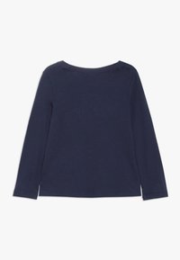 Navy blue long-sleeve shirt with crew neckline, shown from the back against a plain white background.