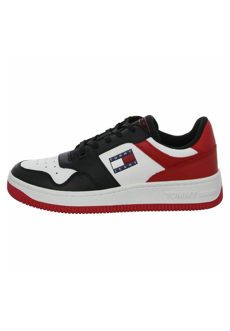 Sneaker in pelle con una combinazione di colori nera, bianca e rossa. Presenta un logo prominente, punta arrotondata e suola bianca testurizzata con accenti rossi.