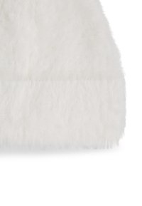 White faux fur fabric with a soft, fluffy texture; features a smooth, flat edge at the bottom. Suitable for various textile applications.