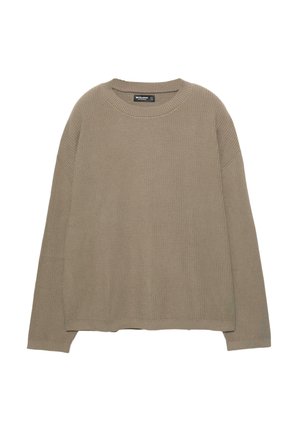 Maglione lungo beige a maniche lunghe con collo rotondo e polsini e fondo a coste, posato su una superficie piana.