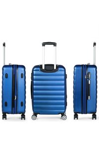 Maleta rígida azul con textura de costillas horizontales, doble cremallera, asa telescópica y cuatro ruedas para movilidad.