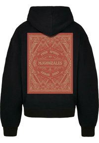 Black hoodie featuring a large red graphic design on the back, with intricate patterns and the text "FREE SPIRIT" and "MJGONZALES 2024."