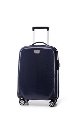 Valigia rigida navy con finitura texture, manico estensibile, quattro ruote e chiusura a zip. Presenta una piccola placca metallica con il marchio.