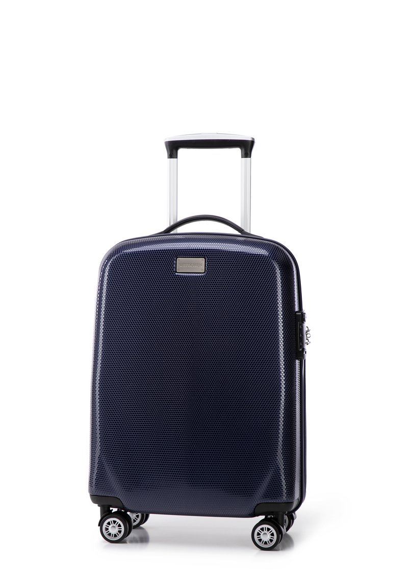 Valise rigide bleue marine avec une finition texturée, poignée extensible, quatre roues et fermeture éclair. Présente une petite plaque métallique de marque.