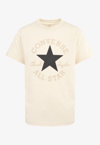 Kremowa koszulka z bawełny z okrągłym dekoltem. Posiada dużą czarną gwiazdę i napis "Converse All Star" w beżowym kolorze wokół niej.